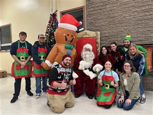 Staff visits with Santa at the 2023 Tree Lighting