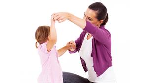 picture of adult and child holding hands and dancing
