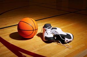 picture of basketball and sneakers on gym floor