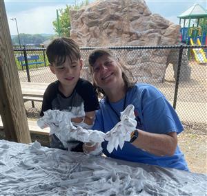 camper and staff participating in sensory play with shaving cream